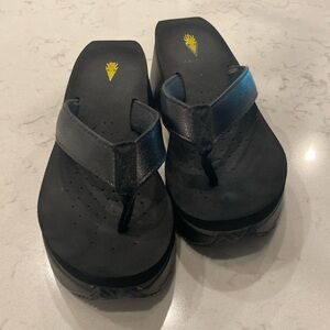 Volatile black leather flip flops